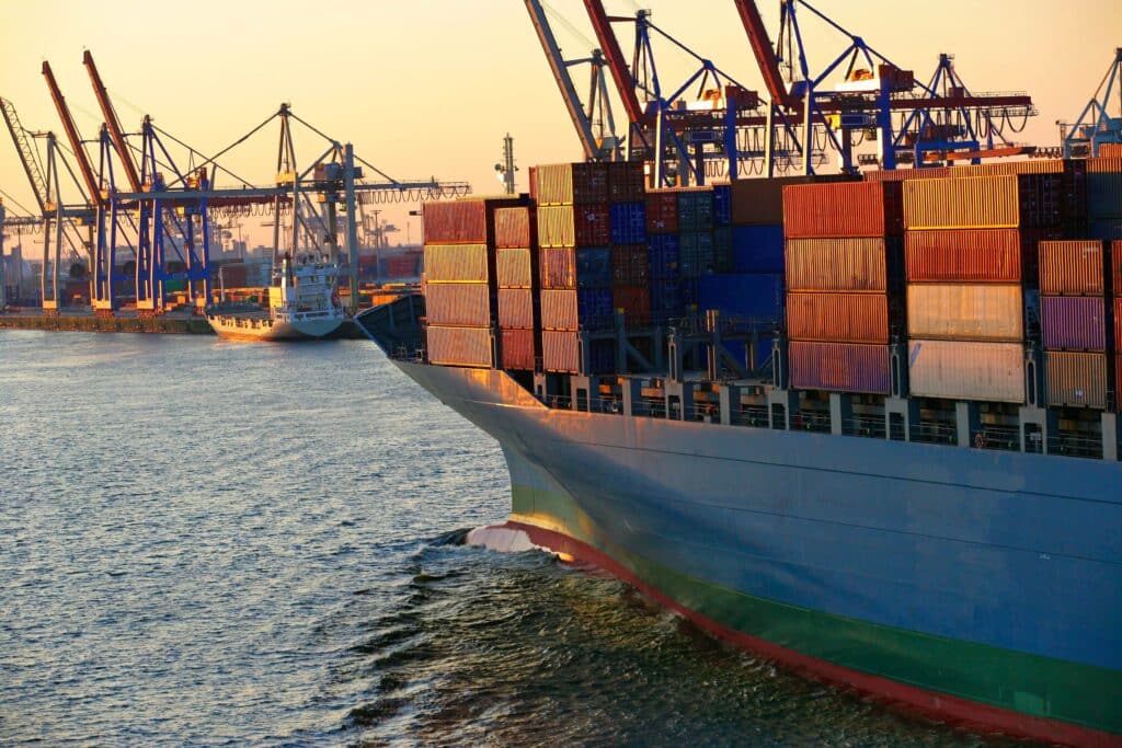 Cargo ship departing port as multiple port calls are handled across terminal operations