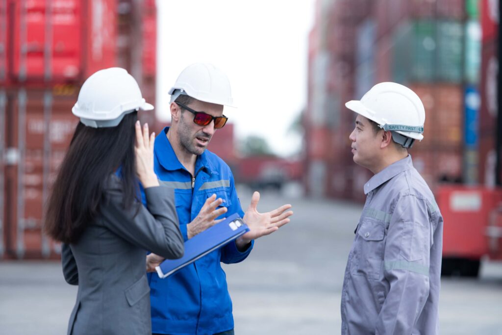 port workers discussing how to handle avendor disputes in port operations