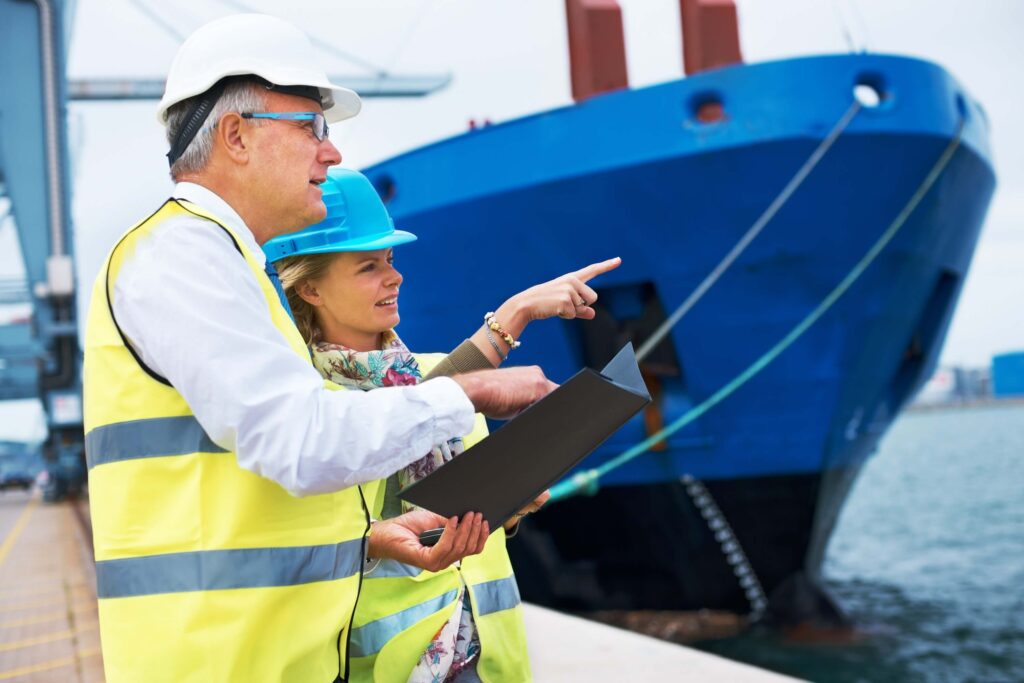 Dock workers reviewing vessel details while managing multiple port calls at the port