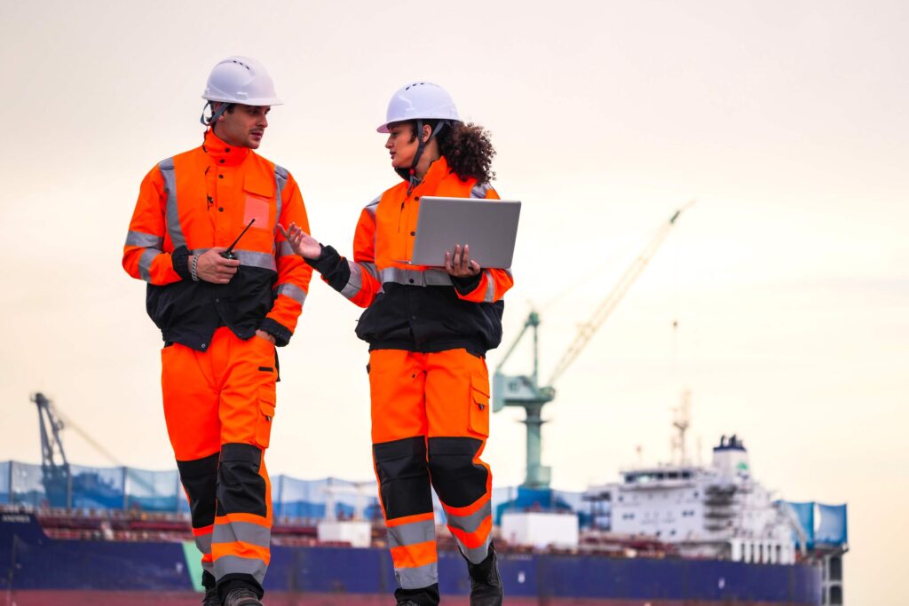 Port workers coordinating logistics during multiple port calls at a shipping terminal