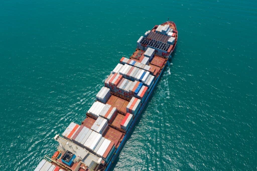Aerial view of container vessel at sea under charterparty agreement during cargo transit