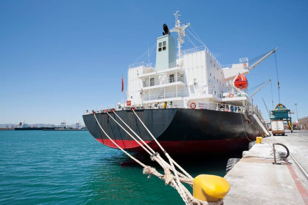 Cargo ship docked at terminal as part of a charterparty agreement port call