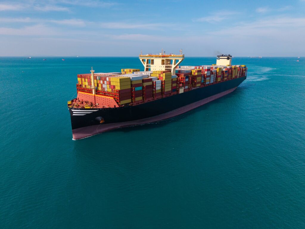 Container ship transporting cargo across open water as part of global port operations