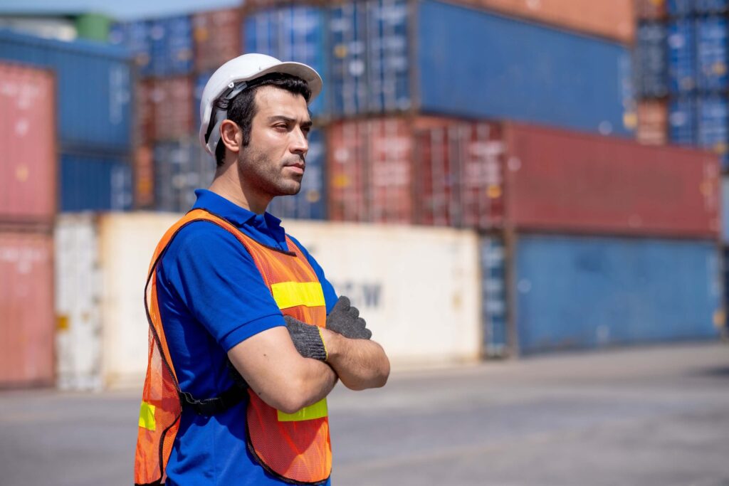 Port worker overseeing operations demonstrating hands-on port call management at terminal