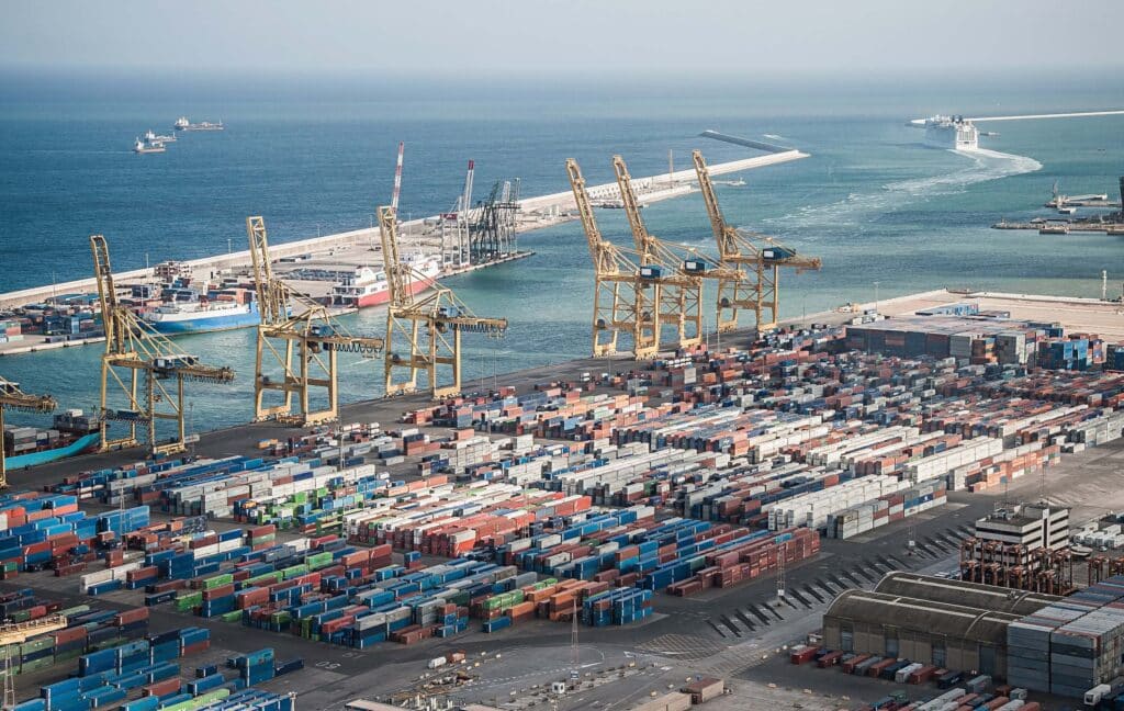 Busy container terminal with cranes and vessels highlighting large scale port call management