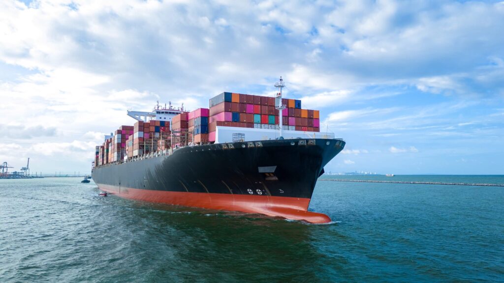 Container vessel approaching port during a call that requires timely principal updates and structured reporting