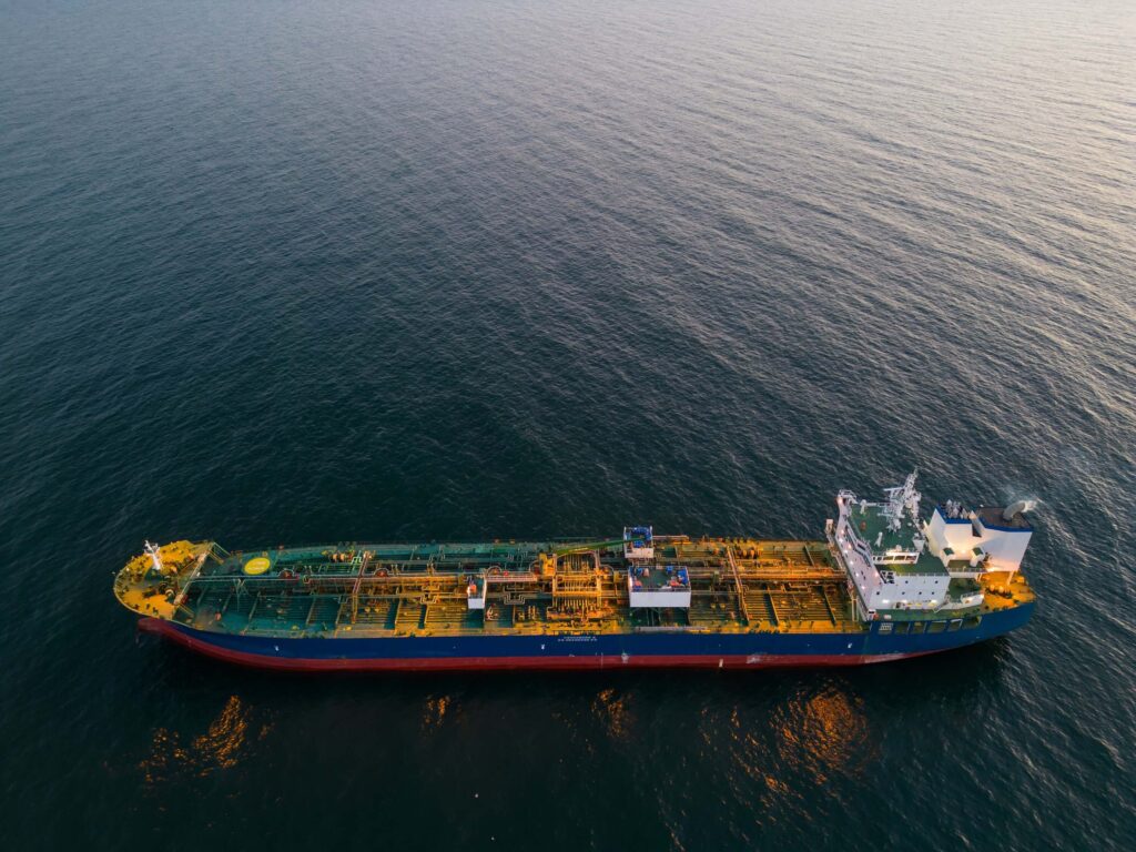 Aerial view of oil tanker at sea with full deck layout visible, highlighting vessel readiness and routing within bunker call coordination planning.