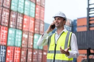 Vessel agent on a phone call at a container terminal coordinating port call updates with stakeholders