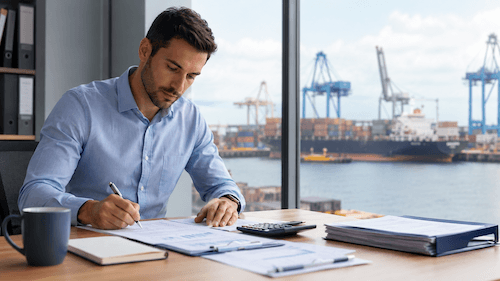 Port office professional reviewing financial paperwork for QuickBooks for shipping companies