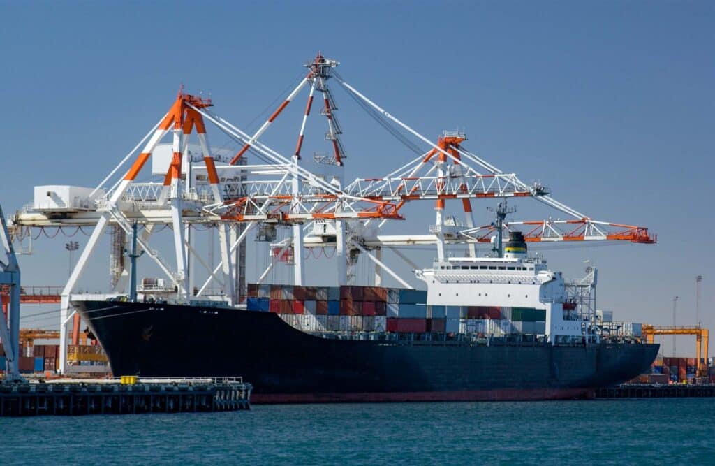 Container ship at port representing QuickBooks for shipping companies and maritime accounting operations
